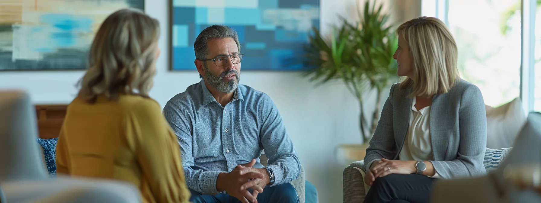 a middle-aged couple consulting with a financial planner in an office setting.