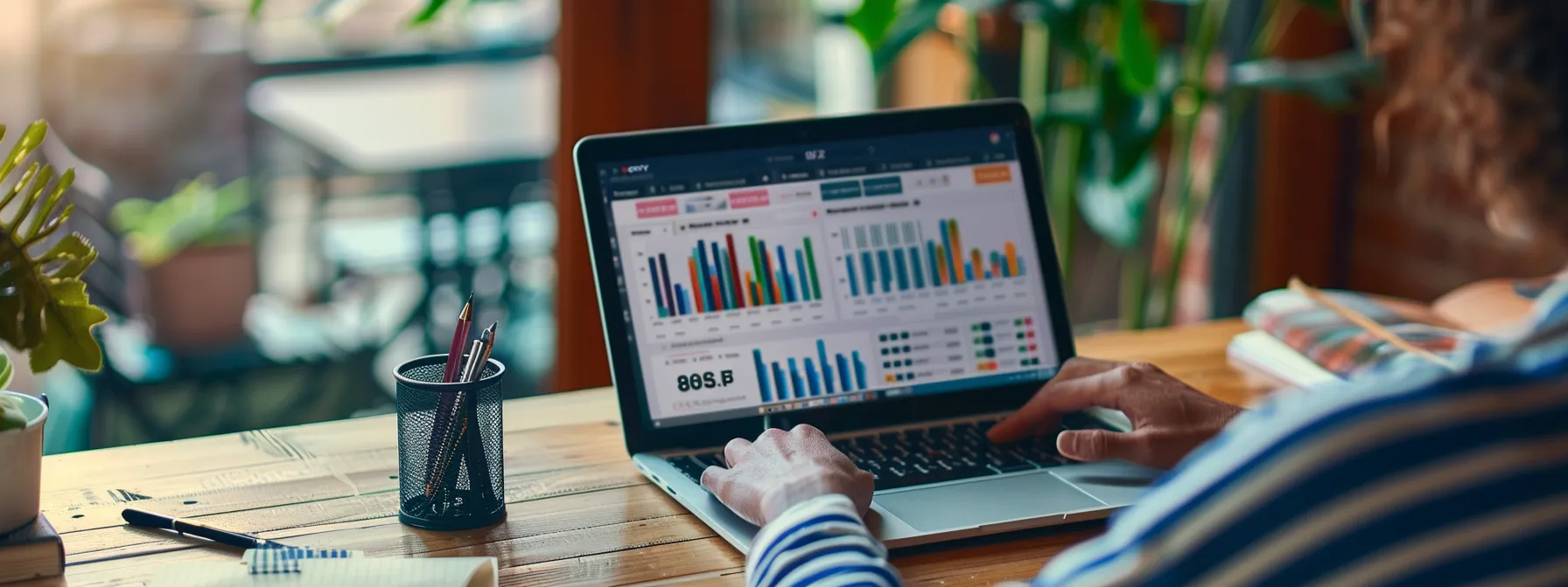 a person sitting at a desk with a laptop, comparing different refinance options on the screen.