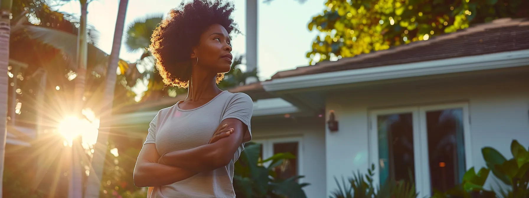 a homeowner in miami standing proudly in front of their newly renovated home, showcasing the benefits of a home equity loan.